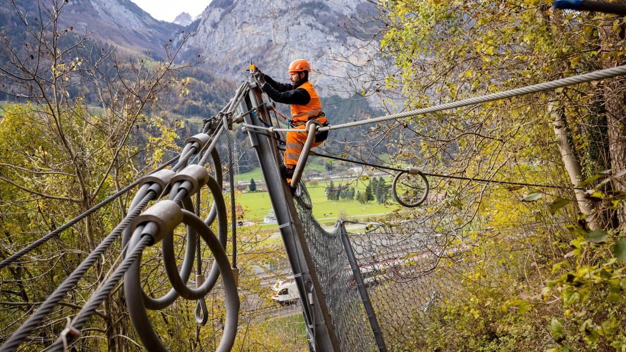 Maintenance work on a natural hazard alarm system sensor.